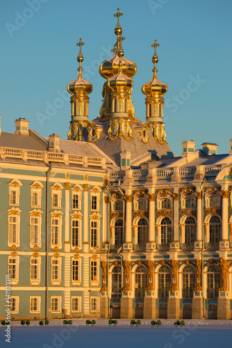 Domes of Church of the Resurrection of Catherine Palace in beams of the sunset sun close up. Tsarskoye Selo, Russia
