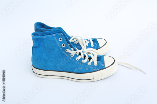 Pair of new blue sneakers isolated on white background