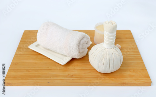 Spa herbal compressing ball with towels and Salt Scrub, Spa concept on bamboo board against white background