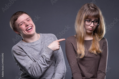 Sneering young man and woman photo