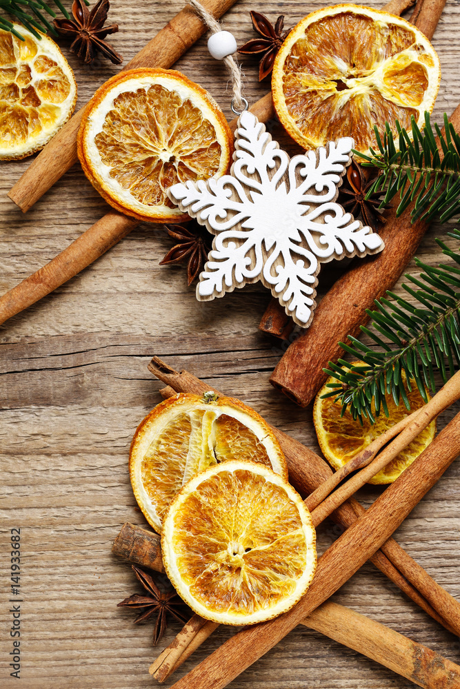 Christmas background with cinnamon sticks, dried oranges and fir branch. Christmas background with cinnamon sticks, dried oranges and fir branch.