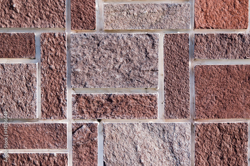 Background of brown hewn stone of rectangular shape photo