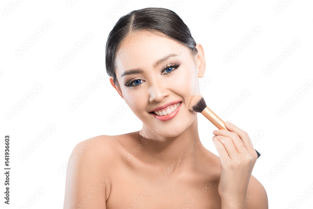 Beauty shot of young pretty asian woman has blue eyes with clear skin use brush on her cheek with white background Beauty shot of young pretty asian woman has blue eyes with clear skin use brush on her cheek with white background