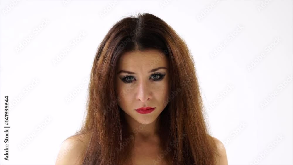 Close-up of angry frustrated young woman on white background Close-up of angry frustrated young woman on white background