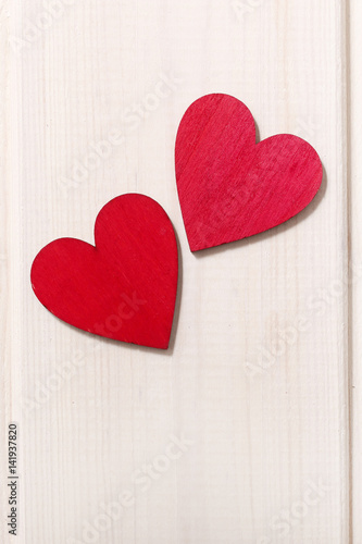 Red hearts on wooden background.