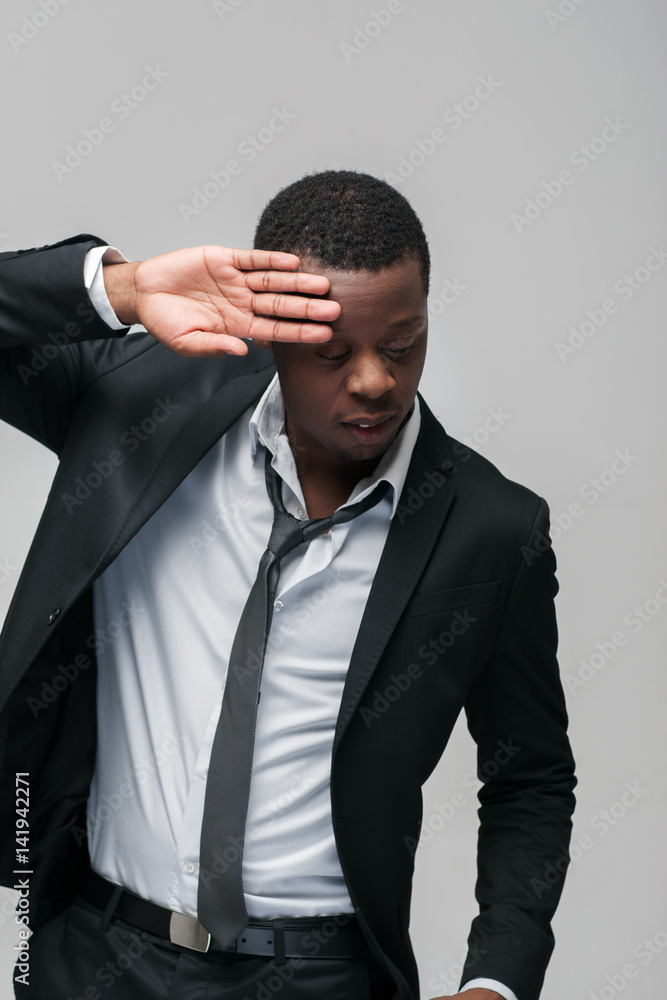 Black afroamerican guy on grey background. Closed face, rejection, separated, reluctance to see, indifference, ignorance Black afroamerican guy on grey background. Closed face, rejection, separated, reluctance to see, indifference, ignorance
