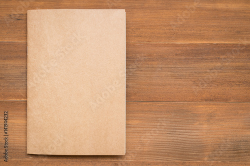 blank book cover on brown wooden background