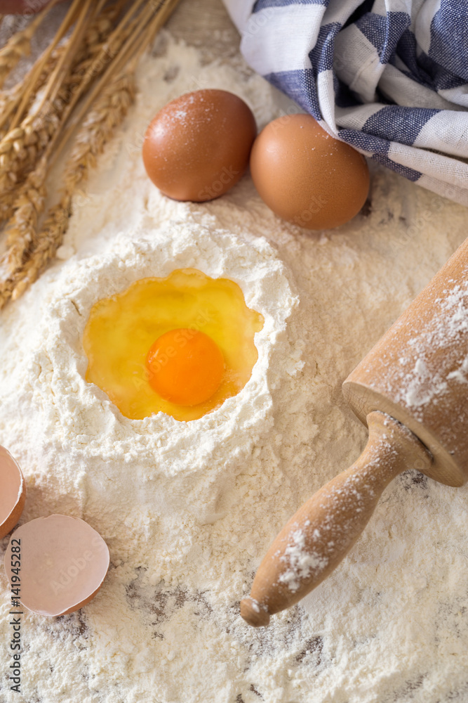 eggs, dough, flour and rolling-pin on wooden table. eggs, dough, flour and rolling-pin on wooden table.