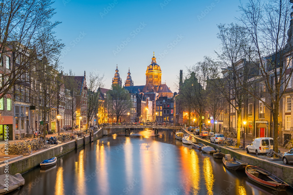 Church of Saint Nicholas in Amsterdam city at night in Netherlands Church of Saint Nicholas in Amsterdam city at night in Netherlands