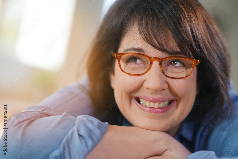 Portrait of cheerful mature woman with eyeglasses