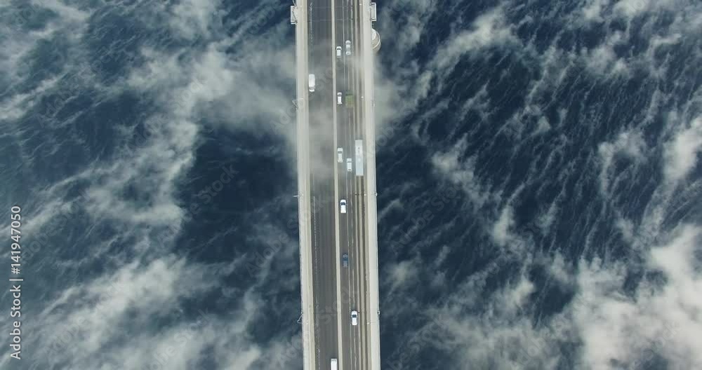 Amazing urban landscape. View of the bridge in the fog top down. Nadir. Aerial View. Amazing urban landscape. View of the bridge in the fog top down. Nadir. Aerial View.