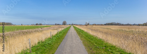 Panorama of a narrow road through the countryside in Groningen