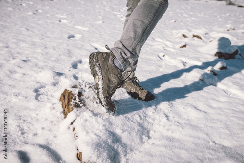 Woman legs and feet on the snow, trekking © elenaburn
