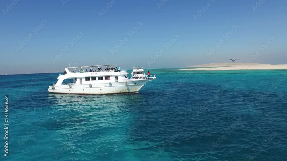 HURGHADA, EGYPT - FEBRUARY 13, 2016: Tourist excursion boat sailing towards Paradise island in the Red sea HURGHADA, EGYPT - FEBRUARY 13, 2016: Tourist excursion boat sailing towards Paradise island in the Red sea