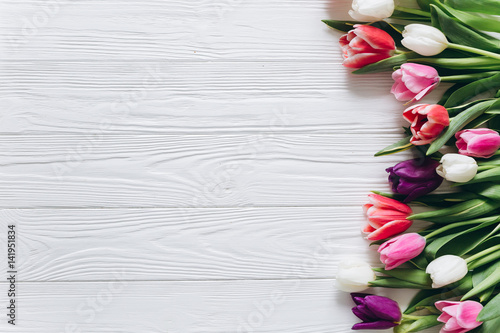 Fototapeta Naklejka Na Ścianę i Meble -  Fresh tulips on a wooden background for Mother's Day.