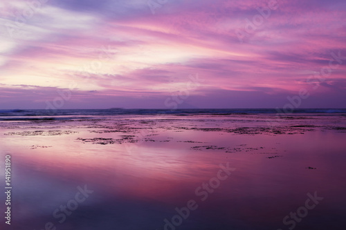 Beautiful sunset with purple sky on beach