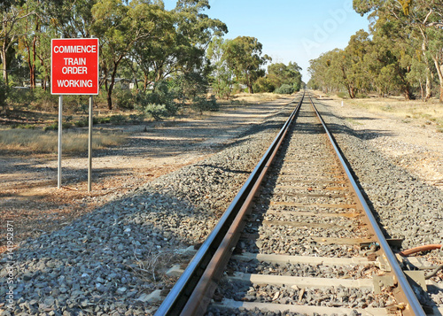 red and white Commence Train Order Working sign and railway tracks
