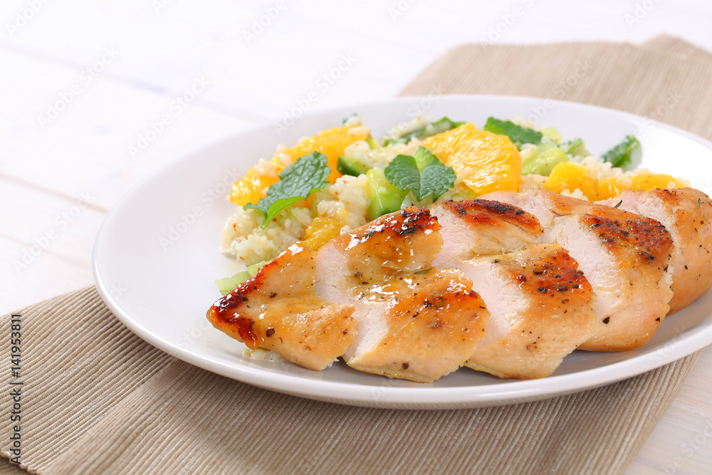 roasted chicken breast with rice and oranges