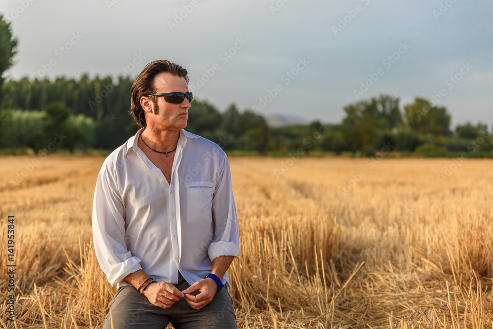 Attractive man rests in the middle of a harvest Attractive man rests in the middle of a harvest