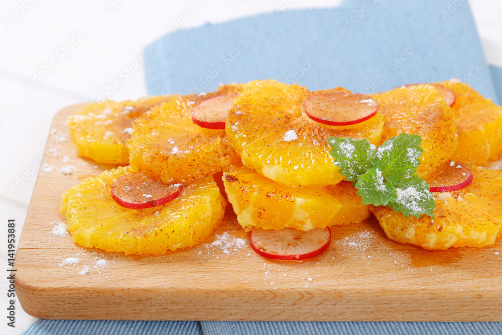 slices of orange, radish and cinnamon slices of orange, radish and cinnamon
