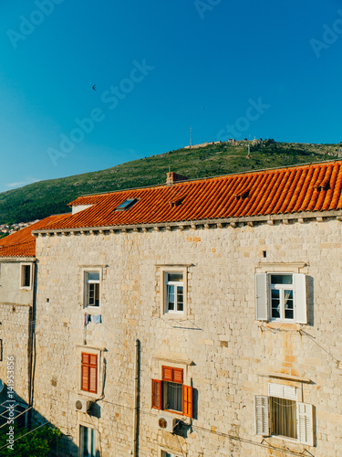 Dubrovnik Old Town, Croatia. Tiled roofs of houses. Church in the city. City View from the wall. © Nadtochiy