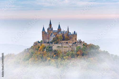 Leinwand Poster German Castle Hohenzollern over the Clouds