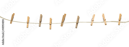 Foto Old wooden clothespins on a rope isolated on  background