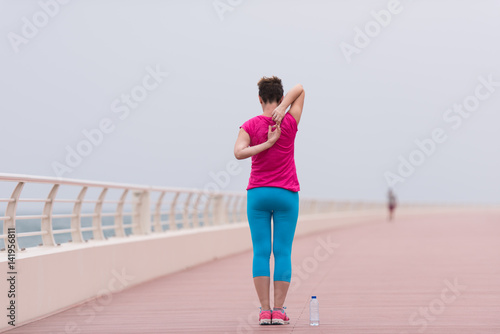 woman stretching and warming up on the promenade © .shock