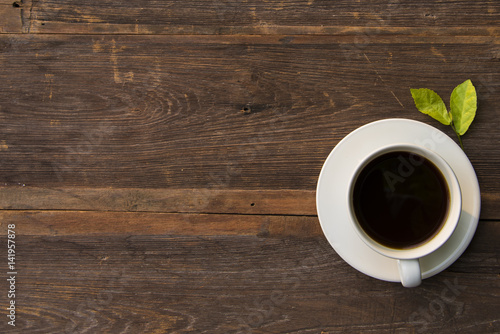 Coffee cup top view on wooden table background