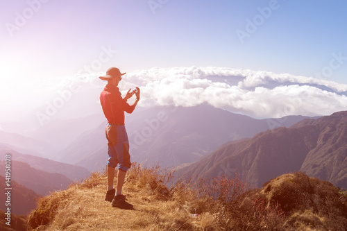 Person taking Photo Mountain Sunny Sky on Camera Phone