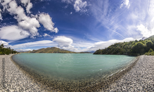 shore of blue lake and clouded sky in patagonia at daylight photo