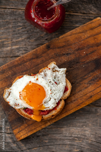 Vegetarian beetroot sandwich with egg, spinach and red chili jam
