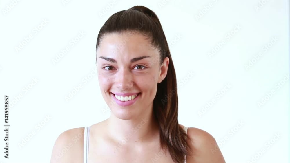Close up of beautiful smiling woman without makeup looking at camera Close up of beautiful smiling woman without makeup looking at camera