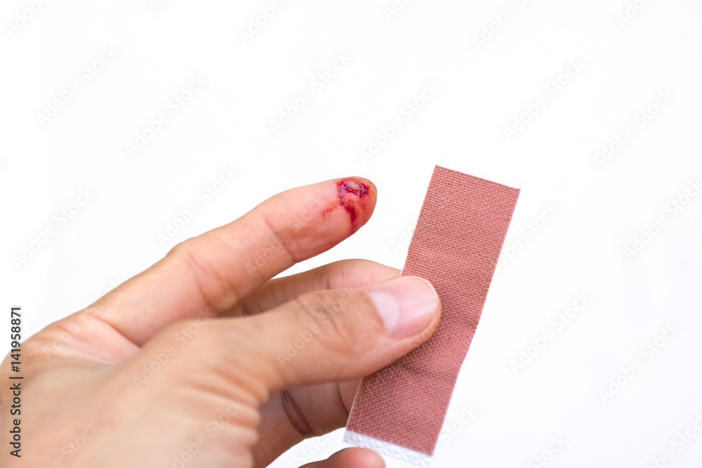 When a small wound, such as finger was cut hand, need to use the adhesive  bandage. To prevent infection disease. Stock Photo