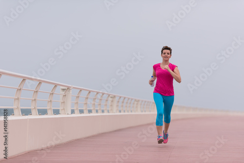 woman busy running on the promenade