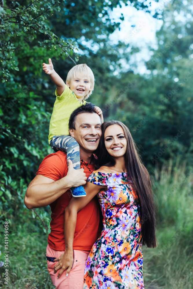 Fototapeta premium Happy smiling family in green summer park
