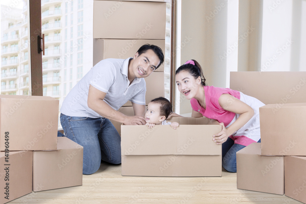 Happy family plays with cardboard near the window Happy family plays with cardboard near the window