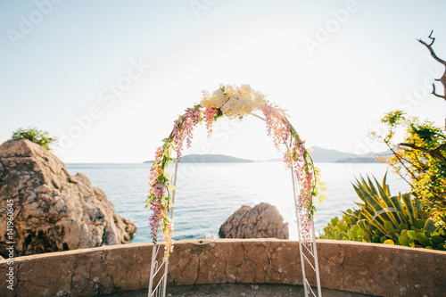 Forged wedding arch. Wedding on the sea at sunset  Montenegro  Przno city
