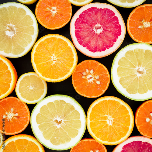 Citrus fruits isolated on black background. Flat lay, top view. Fruit colorful background