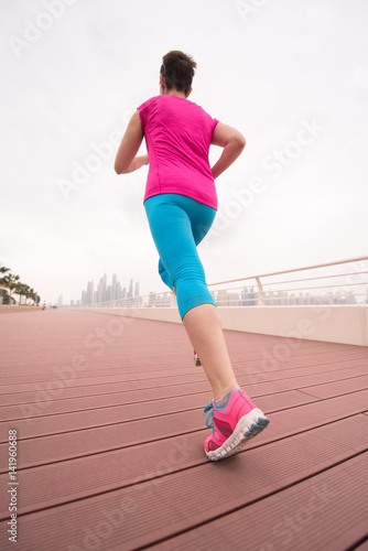 woman busy running on the promenade