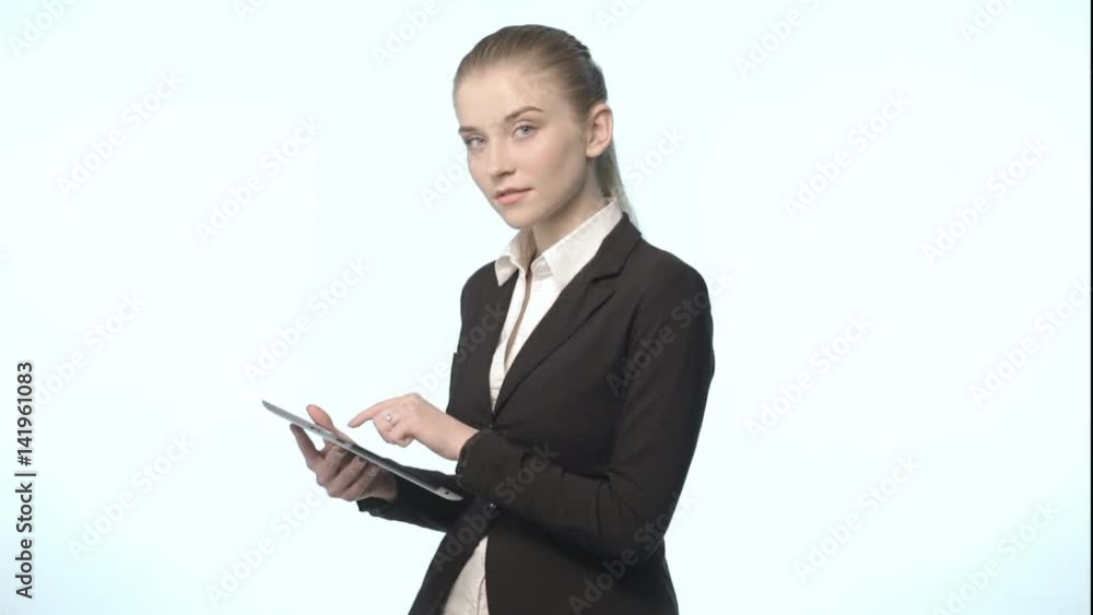 An attractive woman in a business suit with tablet An attractive woman in a business suit with tablet