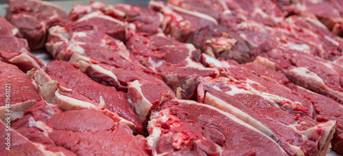 Pieces of fresh beef lying on the counter on the market. Red meat
