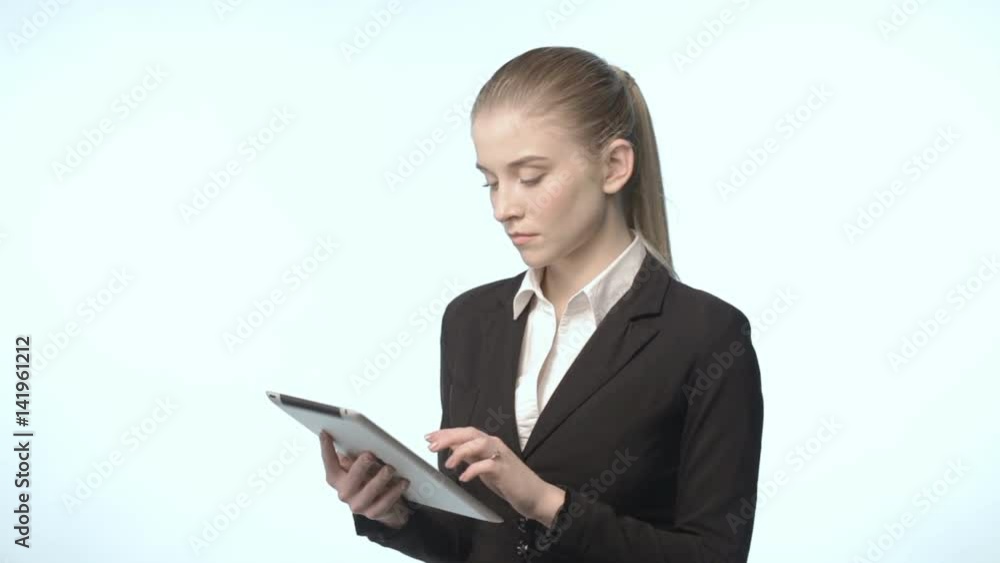 An attractive woman in a business suit with tablet An attractive woman in a business suit with tablet