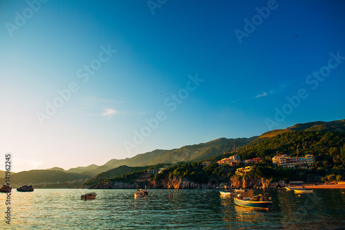 Przno, Montenegro. Fishing boats in the sea, near the beach © Nadtochiy