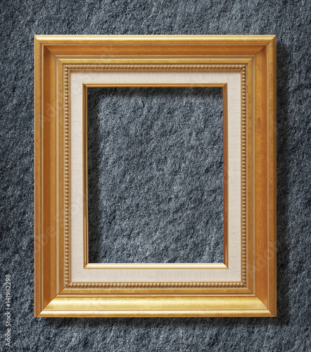 gold frame on Dark grey black slate background or texture.