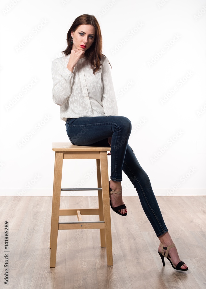 Beautiful model woman sitting on wooden chair Beautiful model woman sitting on wooden chair