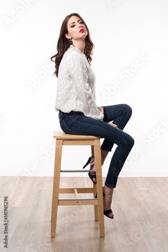 Beautiful model woman sitting on wooden chair