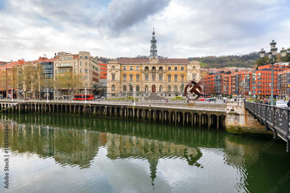 Bilbao town hall reflected at river, Spain