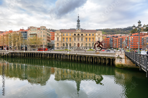 Bilbao town hall reflected at river, Spain