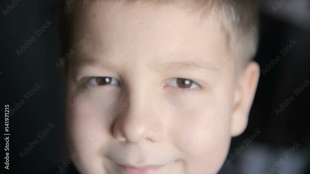 Portrait of a boy close-up on a black background. Full hd video Portrait of a boy close-up on a black background. Full hd video